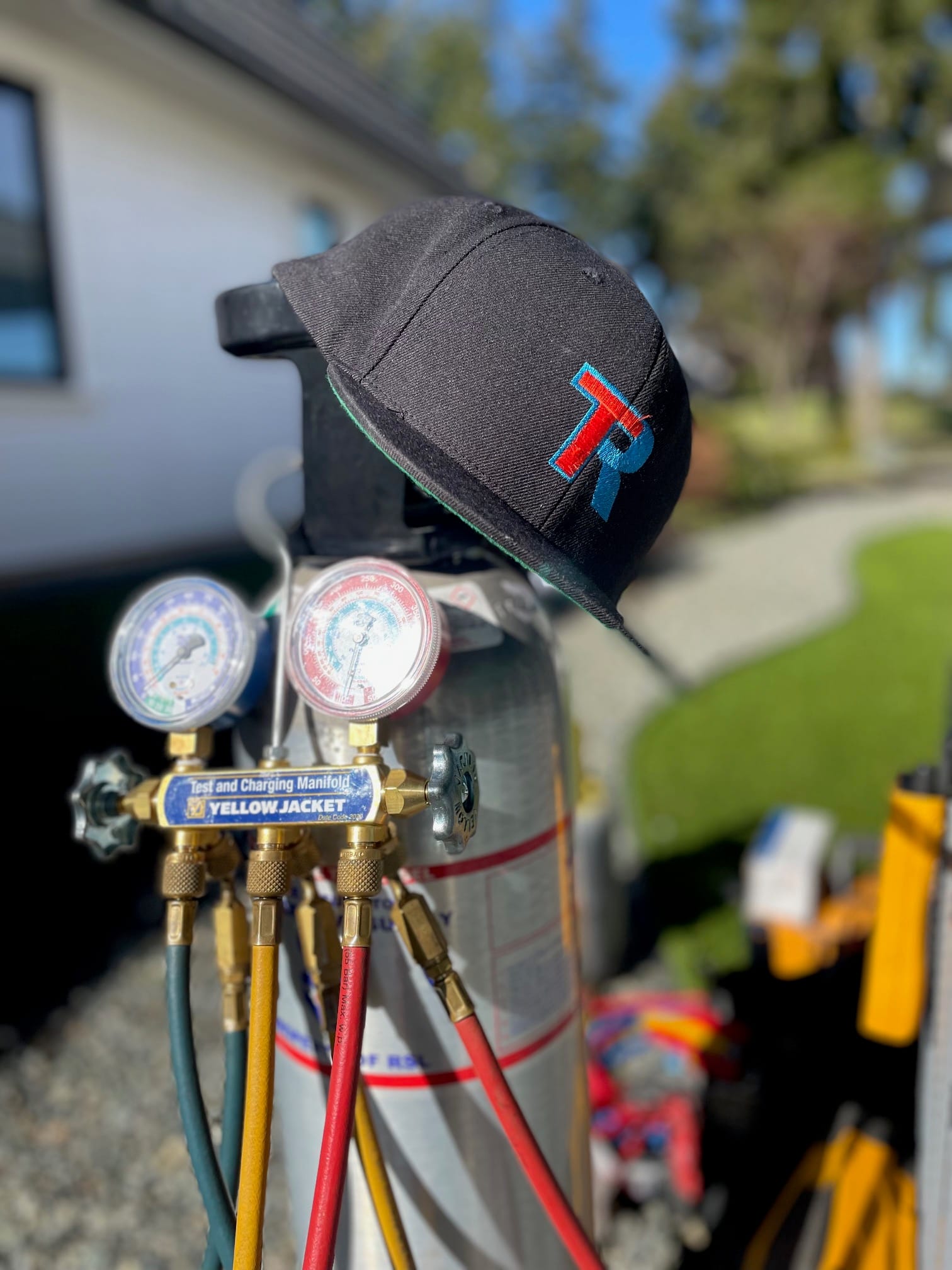 A Temprite hat on top of a tank on a bright blue sky day