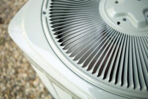 Top view of an outdoor air conditioning condenser unit showing the protective fan grille and metal housing