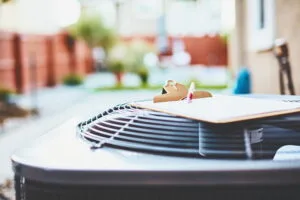 An air conditioner with clipboard sitting on top