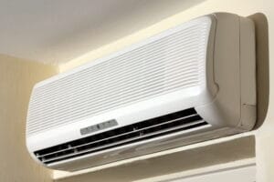 Wall-mounted ductless mini-split air conditioning unit providing efficient heating and cooling for a room