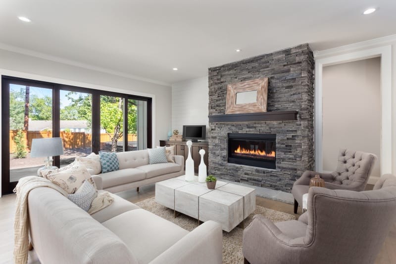 Modern living room with a gas fireplace integrated into the home’s HVAC system, showing efficient heating and balanced indoor climate control